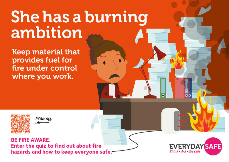 Be Fire Aware poster with a fire starting at a messy desk. Text reads: 'She has a burning ambition. Keep material that provides fuel for fire under control where you work'