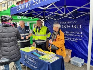Vision zero Three stall holders stood behind Security Services table at Vision Zero event